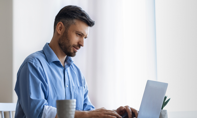 A person working at a computer at home