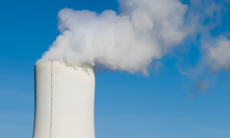 Image of a nuclear cooling tower against a blue sky