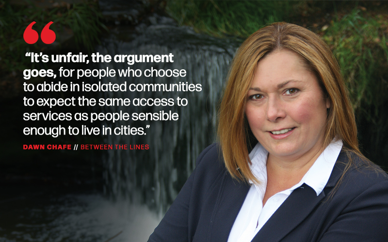 The words: “It’s unfair, the argument goes, for people who choose to abide in isolated communities to expect the same access to services as people sensible enough to live in cities.” appear at the left of a portrait style image of a businesswoman in a dark suit jacket and crisp white shirt, with a waterfall image in the background.
